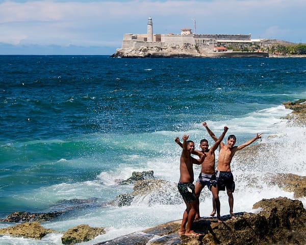 Kids-Playing-on-the-Rocks-with-El-Morro-Havana-Cuba-Copyright-2013-Ralph-Velasco